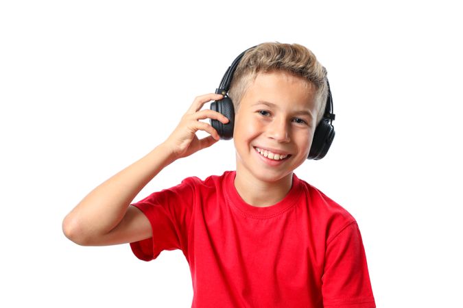Boy in red t-shirt with headphones isolated on blank background