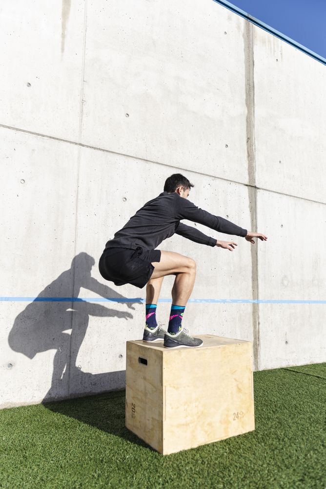 Man training on sports ground near wall