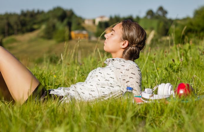 young student lying at the park in a sunny day
