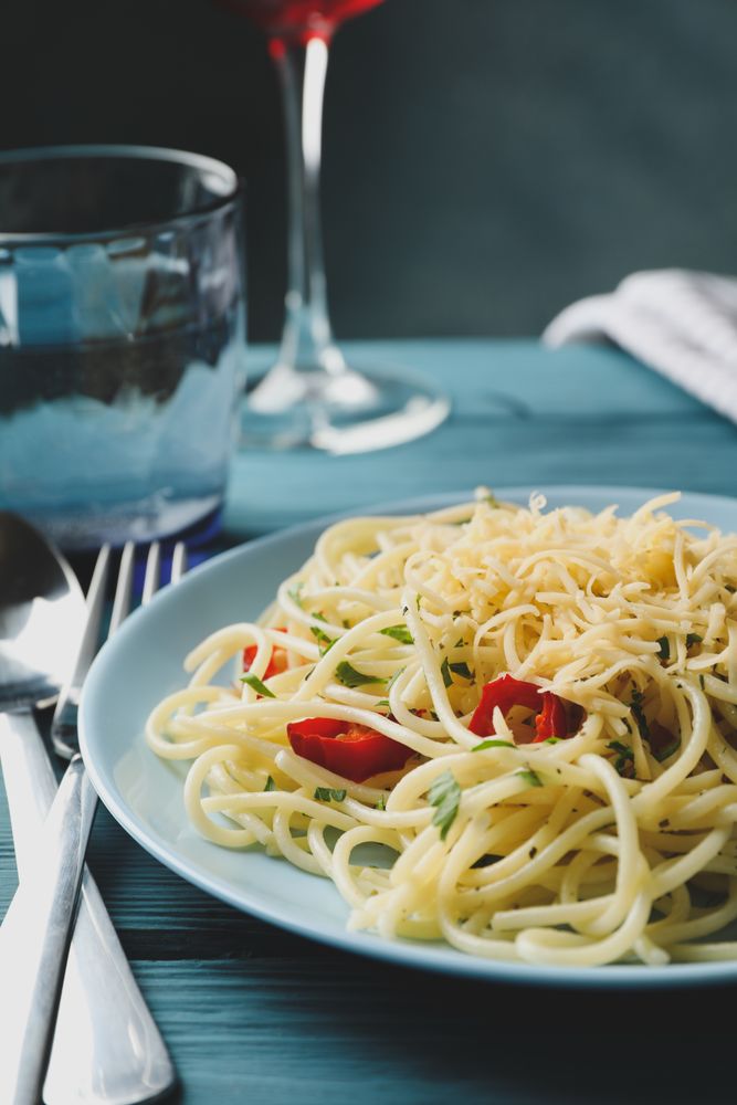 Composition with plate of tasty pasta on wooden background