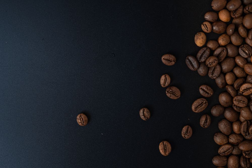 Scattered coffee beans on the side