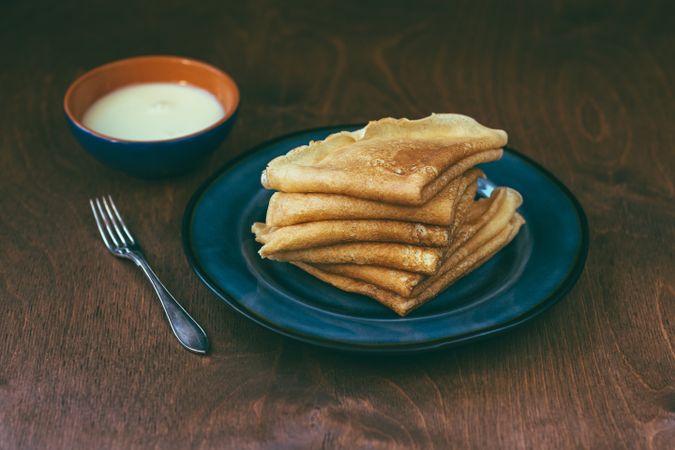 Sauce near stack of blini