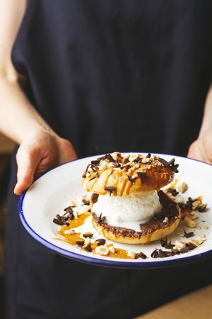 Tasty sweet burger with chocolate crumb and nuts
