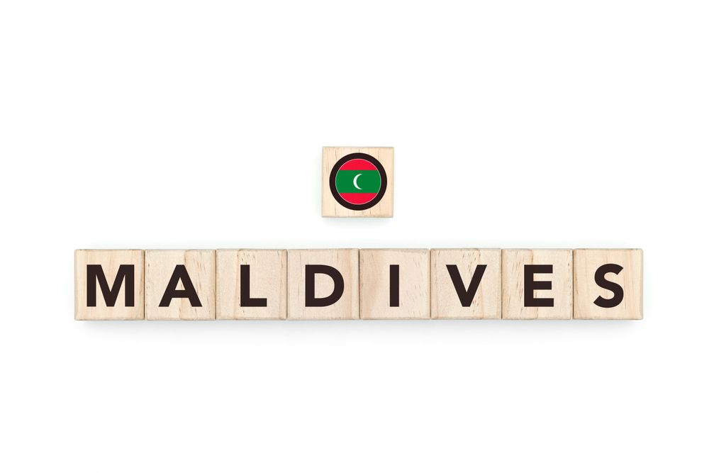 Wooden blocks bearing the name and flag of Maldivas. Maldivian and North Indian Culture, national identity, travel, and geography in a copy space design.