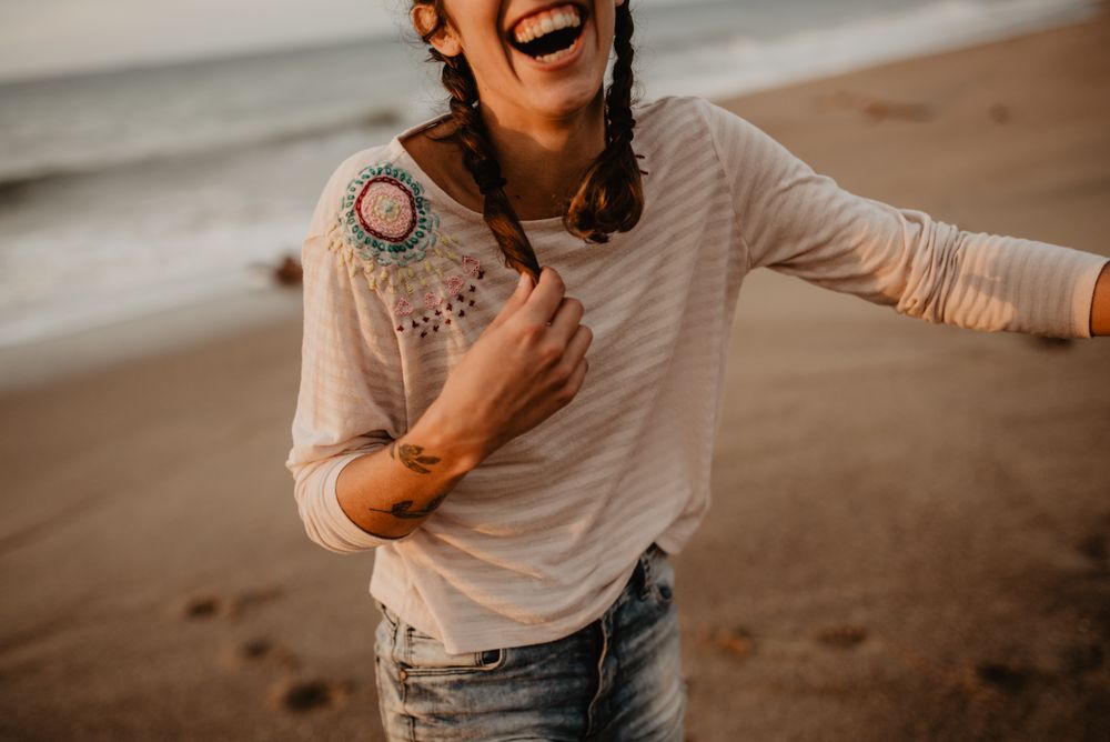Young woman laughing on beach