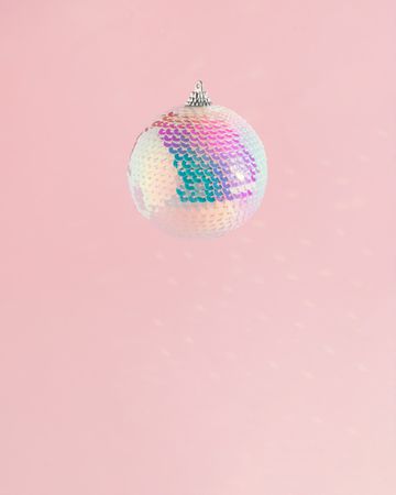 Sequins bauble on pink background
