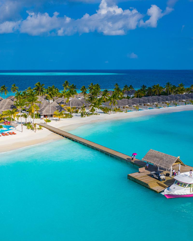 Beach holiday resort with long pier and boat