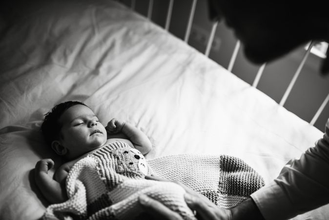 Anonymous father wishing good night to baby