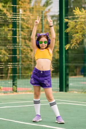 Schoolgirl dancing on sports ground