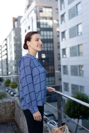 Smiling businesswoman standing on balcony