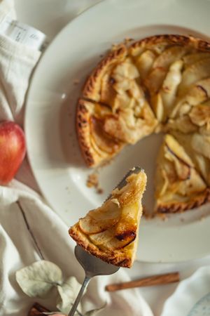 Freshly baked apple tart sliced and ready to plate