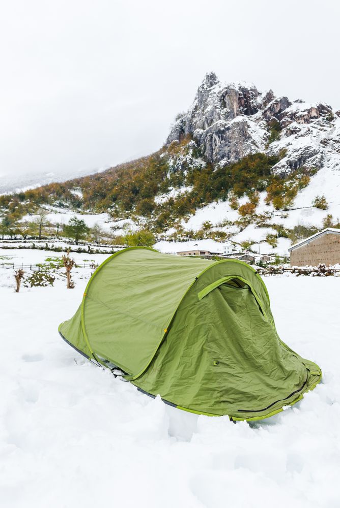 Green tent in snowy landscape