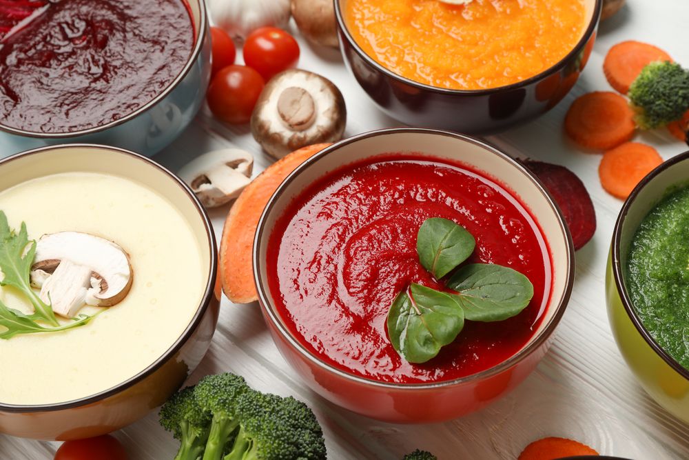 Close up of fresh vegetable soups on table