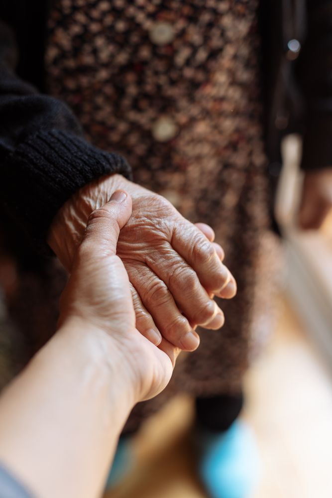 Man holding a mature woman's hand
