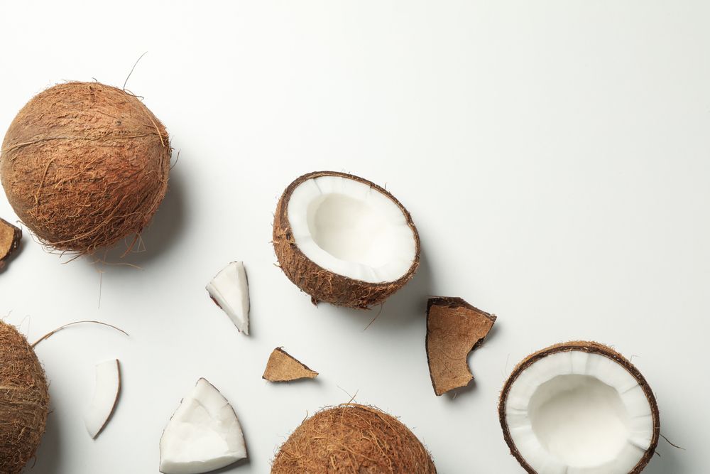 Flat lay with coconut on plain background, top view