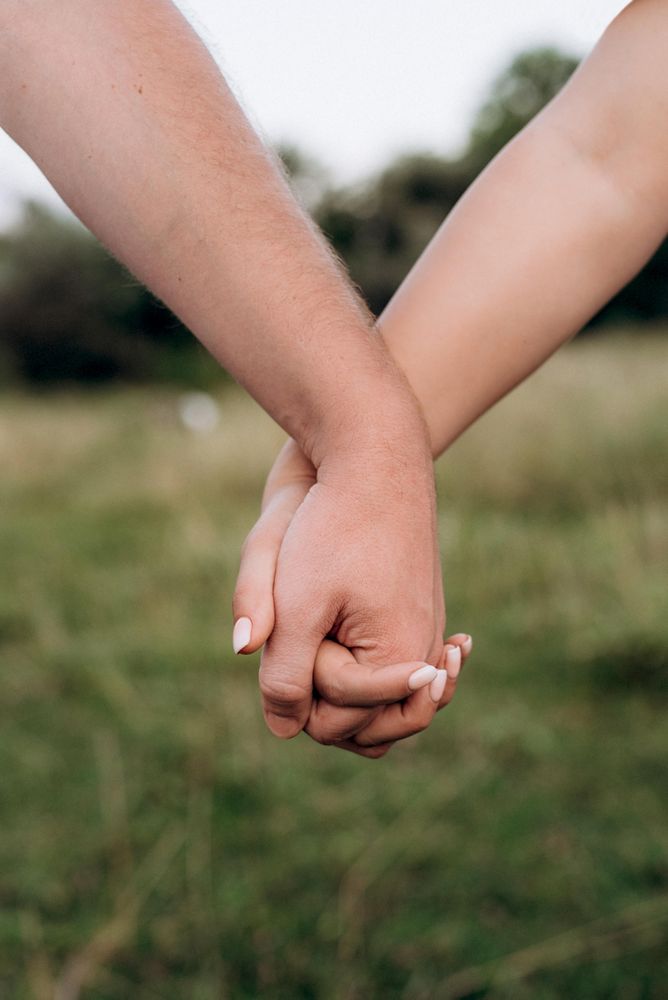 Two people holding hands