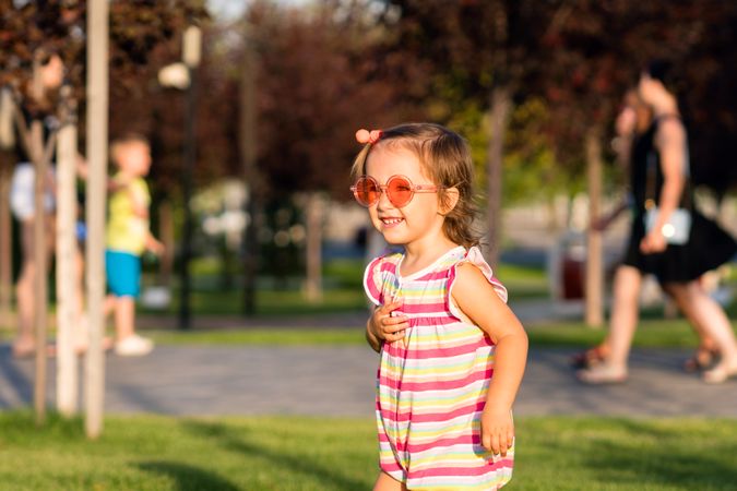 Summery toddler enjoying park outdoors