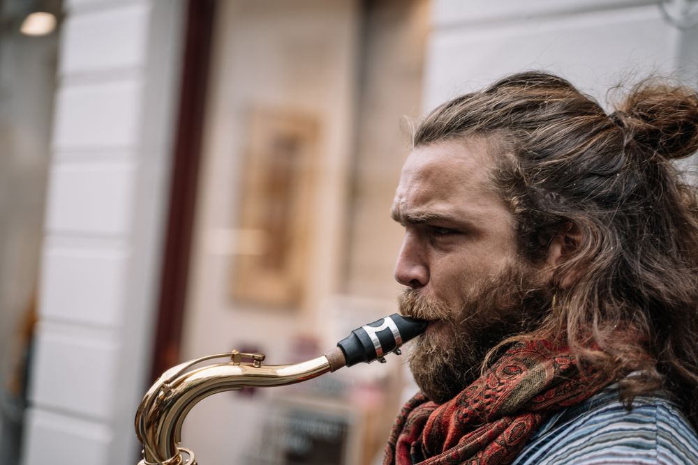 Male saxophonist plays Sax in the street