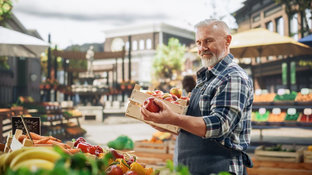 Male Farmer Managing a Small Business on an Outdoors Farmers Market,