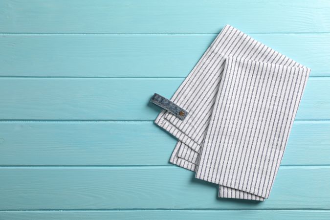 Fabric napkins on color background, space for text