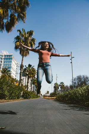 Teen girl walking happily through the streets.