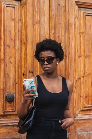 Black woman chatting on smartphone