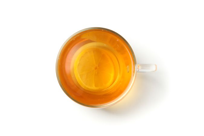 Tea with lemon slice isolated on bright background