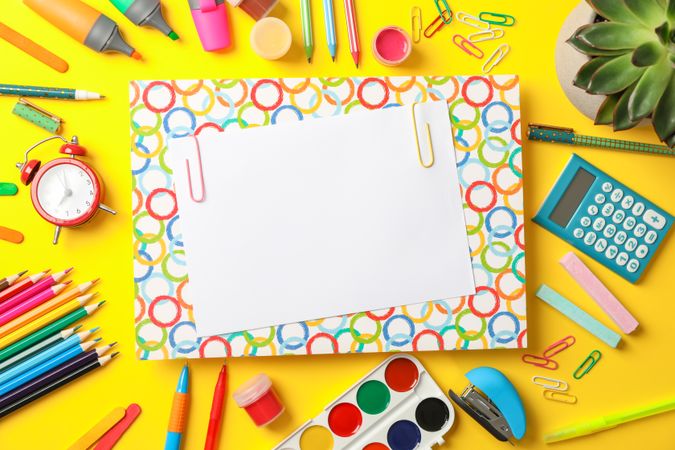 Flat lay composition with school supplies on color background, space for text