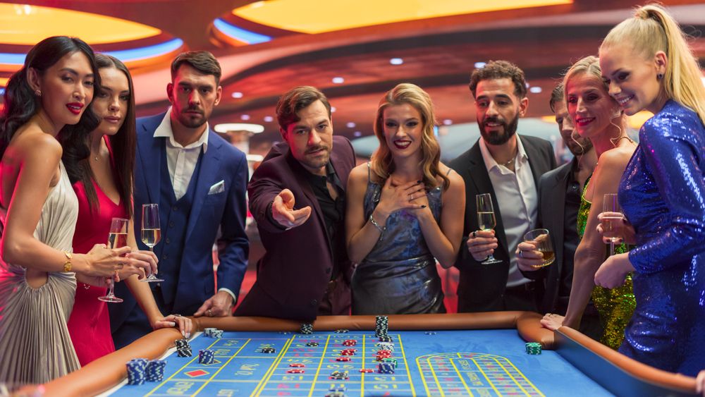 Casino Enthusiasts Making Calculated Bets at a Roulette Table.