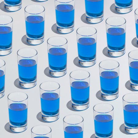 Glass of blue liquid in different rows