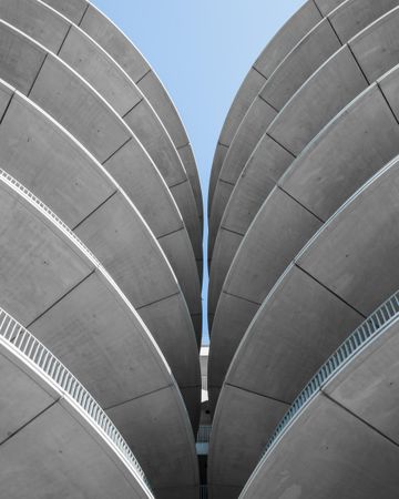 two symmetric cylinder gray concrete buildings
