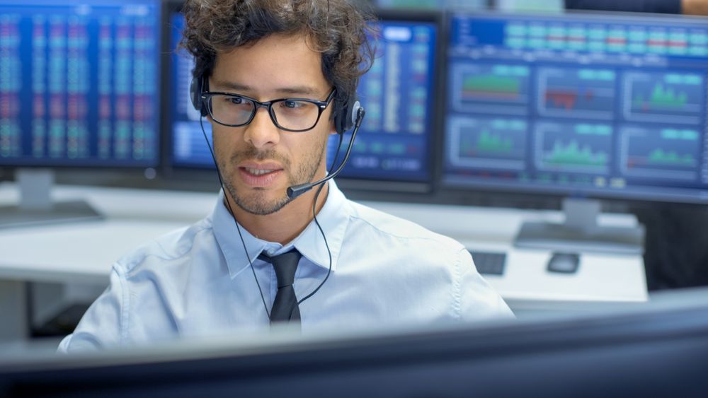 Customer Support Service Representative Talks with a Client Through Headset.