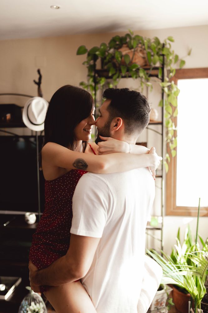 Passionate couple hugging in stylish room