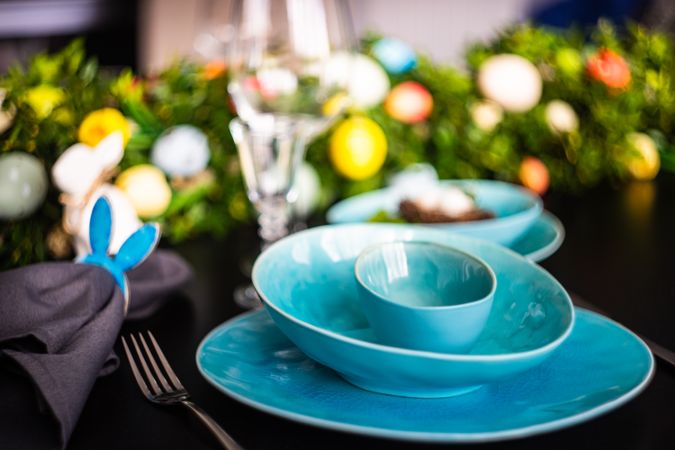 Blue plates on Easter themed table with rabbit napkin ring