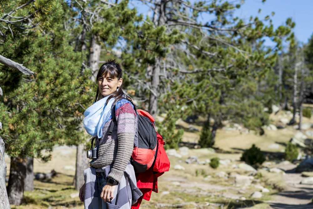 Side view of female hiker in the woods