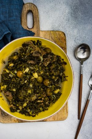 Top view of Chakapuli is a Georgian stew in yellow plate