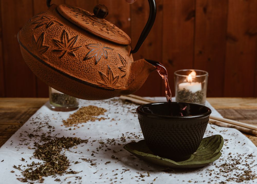 Aromatic tea dates and clay teapot on table