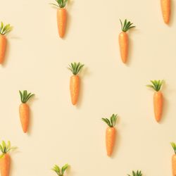 Carrots on pastel yellow background
