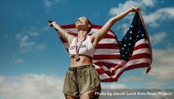 Athlete enjoying victory with US national flag against sky 47lyzb