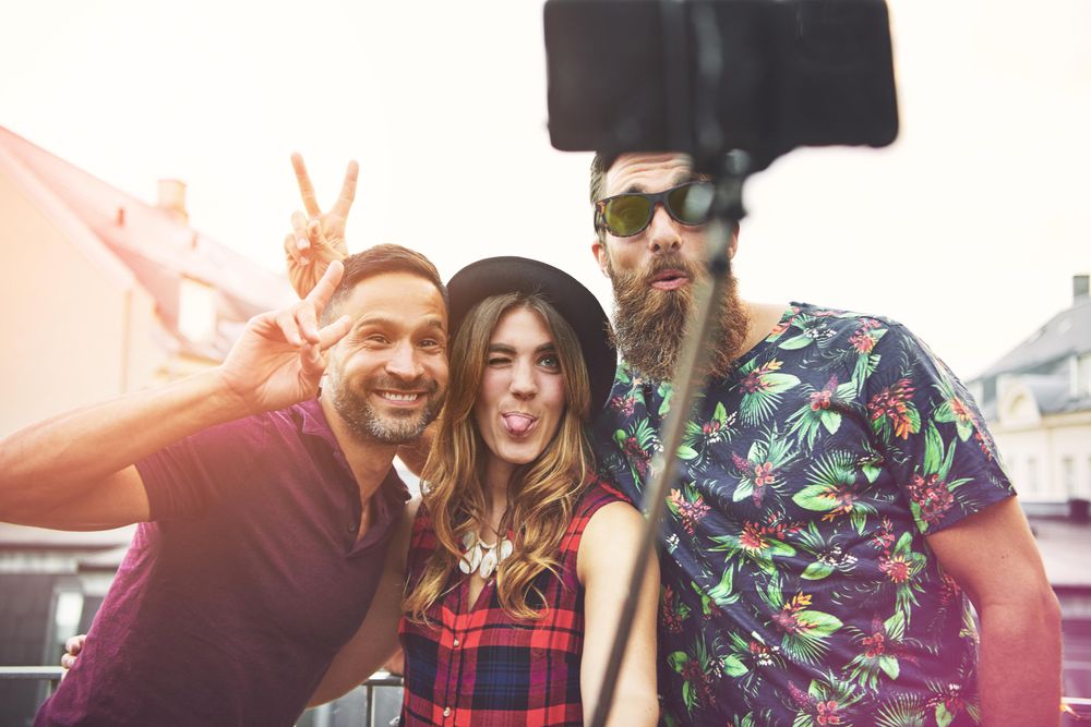 Friends taking a silly selfie outside