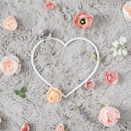 Heart on grey carpet with flowers