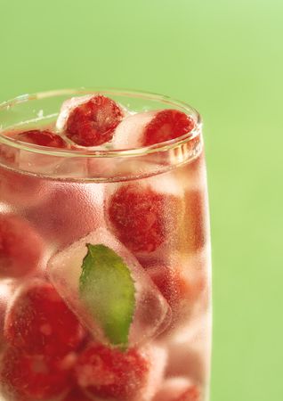 Close up of frozen raspberry and water