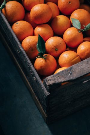 Fresh oranges in an old wooden box
