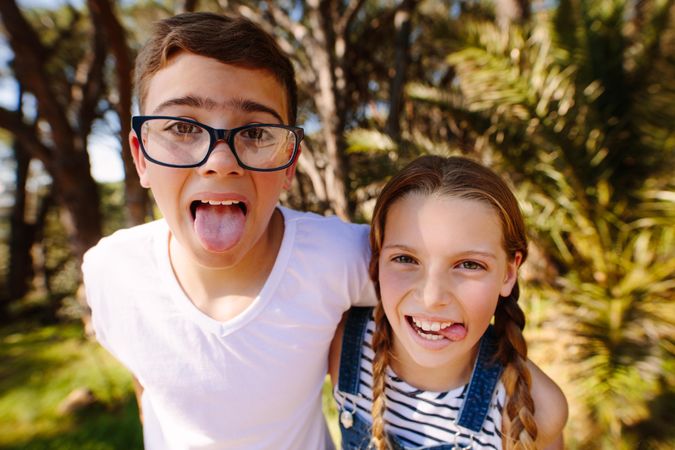 Close up of smiling kids standing in a park having fun together