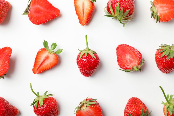 Flat lay composition with strawberries on light background, closeup. Summer sweet fruits and berries