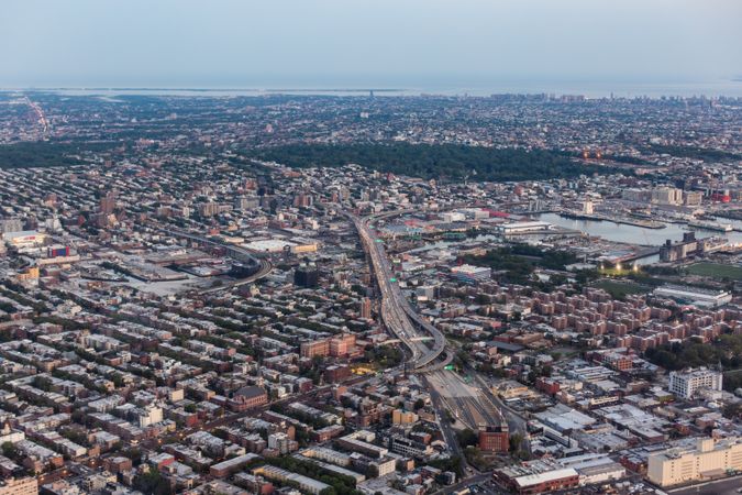 Aerial View of New York City. Helicopter Photo of a Busy Highway in New York City. Panoramic View with Traffic Around a Big City with Skyscrapers in the Background