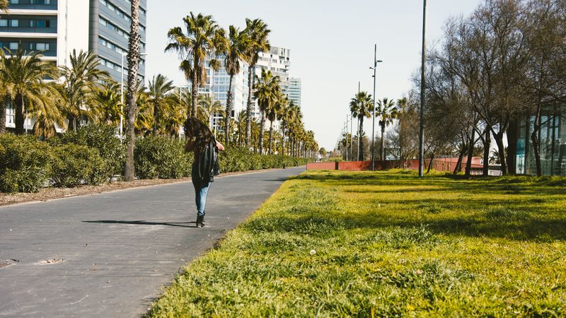 Teen girl walking happily through the streets.