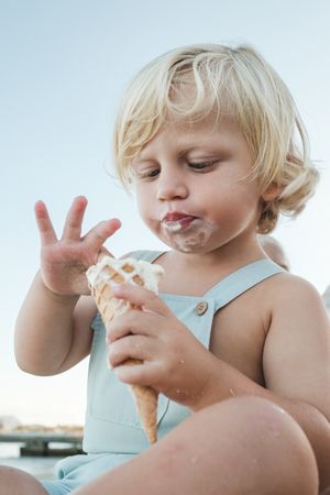 Cute boy enjoying ice cream on beach