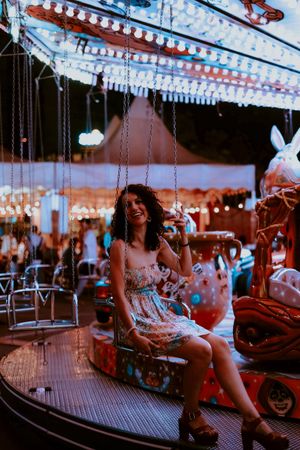 Woman enjoying ride on carousel