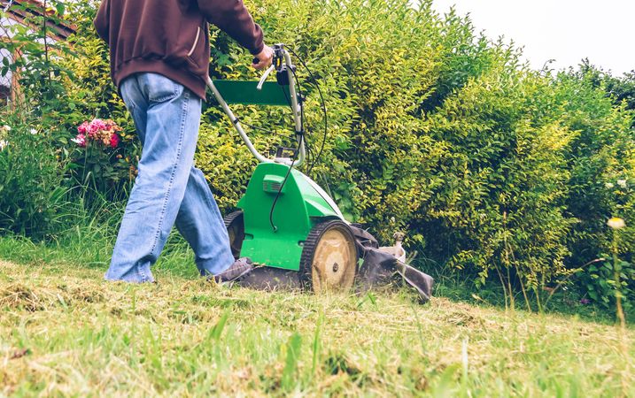 Man mowing the lawn with lawnmower